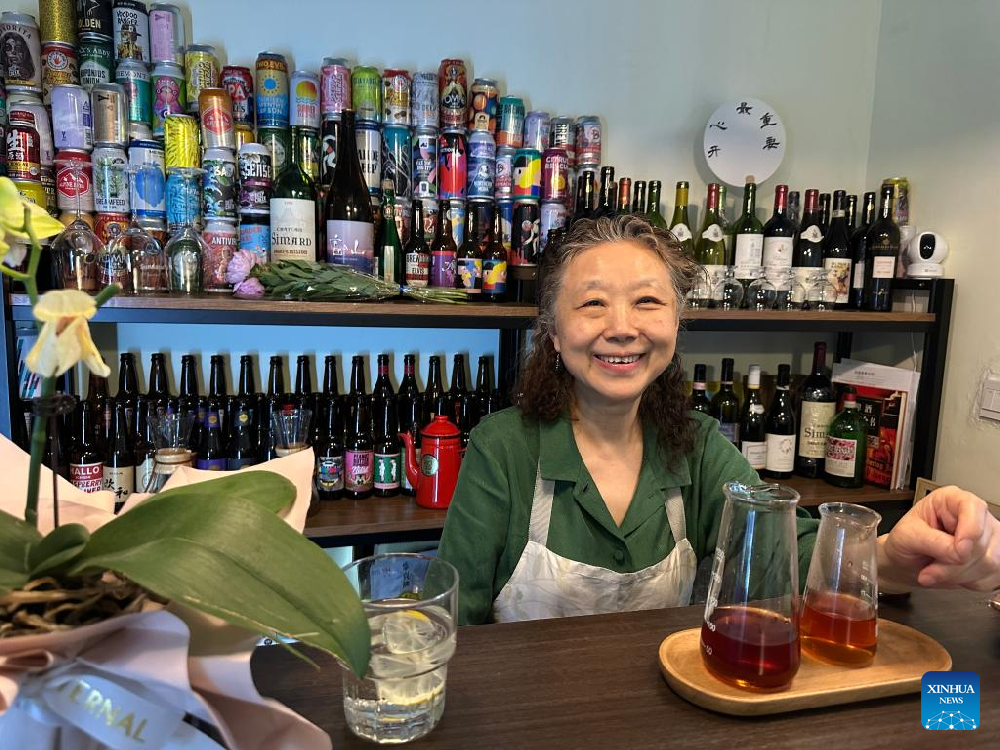 Elderly barista delights young customers with aromatic coffee