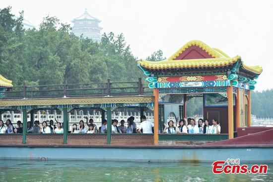 Overseas teenagers take sightseeing boats on Kunming Lake to enjoy the beauty of classical Chinese garden at the Summer Palace in Beijing, Aug. 9, 2023. (Photo: China News Network/Li Jun)