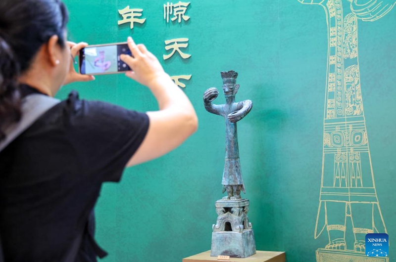 A visitor takes photos of an exhibit at the booth of the Sanxingdui Museum during the 22nd China (Shenzhen) International Cultural Industries Fair in Shenzhen, south China's Guangdong Province, May 22, 2026.
The 22nd China (Shenzhen) International Cultural Industries Fair kicked off here on Thursday, showcasing over 120,000 cultural products. The Creative China exhibition area brings together domestic cultural IPs, sci-tech innovation products, cultural and tourism products, intangible cultural heritage products, and popular creative cultural products. Creative cultural products from more than 30 famous domestic cultural heritage institutions and museums are also showcased during the event, attracting numerous visitors. Photo: Xinhua